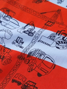 Kids orange striped T-shirt featuring black construction vehicle patterns and soft cotton fabric