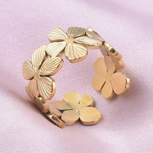 Macro shot of gold adjustable 304 stainless steel ring with relief flower pattern