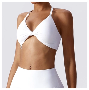 Detailed view of white sports bra featuring unique front twist knot and thin straps