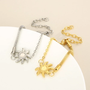 Detail of sun pendant bracelet featuring mesh and link chain in gold and silver finish