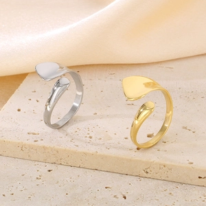 Minimalist adjustable open rings in gold and silver finish on a textured stone surface