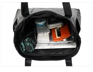 Overhead view of spacious black tote bag interior showing large storage capacity