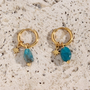 Detailed close-up of gold hoop earrings with amazonite stones and star charms on stone background