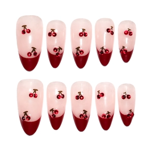Short almond press-on nails with red French tips and 3D cherry rhinestone accents