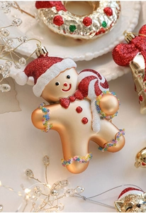 Detail of gingerbread man Christmas ornament with red glitter accents and colorful beads