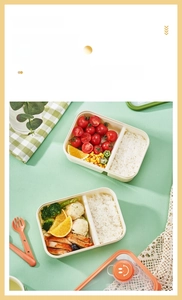 Two-compartment glass bento box with matching orange utensils and seal lid