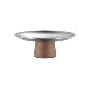 Detail of silver stainless steel dessert plate with a natural brown wooden pedestal base