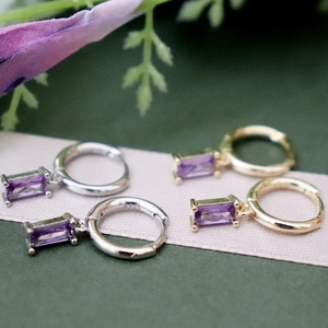 Close-up of S925 sterling silver earrings with purple rectangular zircon pendants