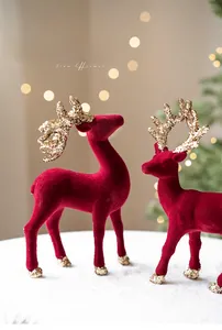 Close-up of red flocked reindeer ornaments with golden glitter antlers for Christmas decor