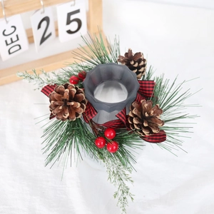 Detail view of Norfolk pine wreath with red and black buffalo plaid bow and red berries