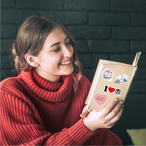 Detail showing waterproof book reading stickers applied on books in a cozy setting