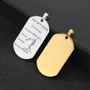 Close-up of engraved silver and gold dog tag pendants for Father's Day gift