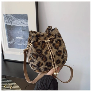 Detail of plush leopard bucket bag featuring gold chain and large faux pearl accents