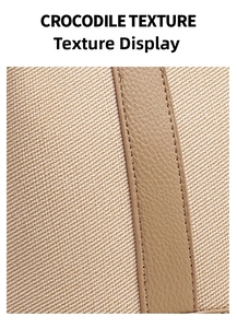 Detail of beige twill fabric and brown crocodile texture leather with neat stitching