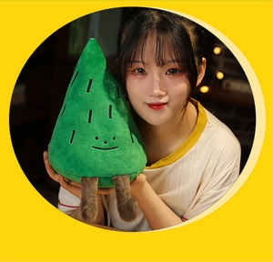 Detailed plush pine tree pillow held by model, soft fabric and embroidered face features