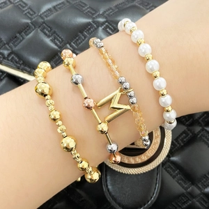 Fashionable beaded bracelet set with gold plating, pearl beads and an M letter charm