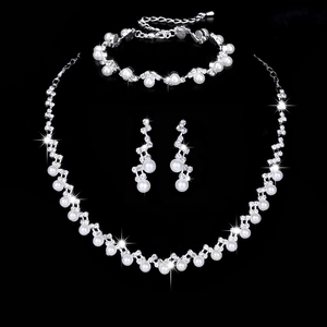 Silver African wedding jewelry set featuring pearl and rhinestone necklace and earrings