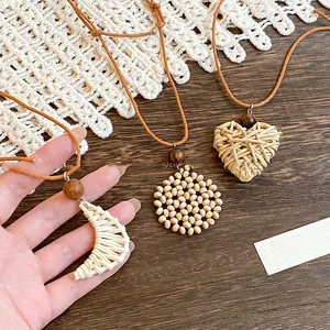 Detailed view of bohemian woven heart, crescent, and circular pendants with wooden beads