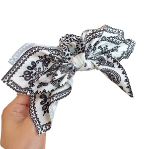 Vintage paisley print bow hair claw clip with black and white floral pattern design