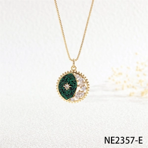 Macro detail of star and moon gold pendant necklace with green surface and zircons