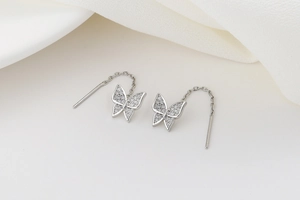 Detail of silver butterfly threader earrings with shimmering zircon pave stones