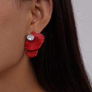 Detailed view of irregular red petal stud earrings with sparkling zircon crystal accent