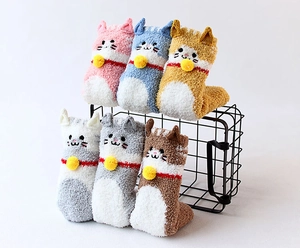 Close-up of six pairs of soft coral fleece cat-themed socks in assorted warm colors