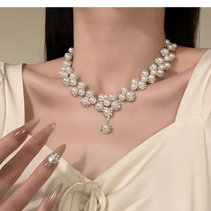 Close-up of pearl flower necklace with crystals on model for a vintage luxury look