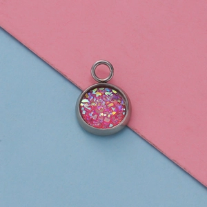 Macro detail of a 12mm stainless steel pendant tray with sparkling pink glitter inlay
