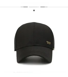 Detail view of cotton baseball cap with golden Sports Style metal logo on black fabric