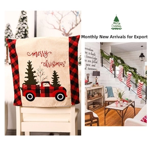 Close-up of burlap Christmas chair cover with red tractor and buffalo plaid border