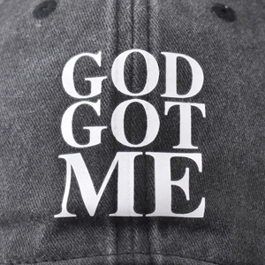 Vintage washed black cotton baseball cap featuring God Got Me white printed lettering