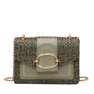 Green tweed crossbody bag with gold chain strap and elegant metallic buckle closure