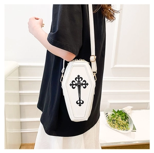 Detail view of white coffin shaped gothic crossbody bag with black cross print