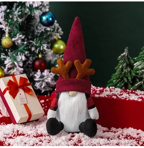 Close-up of a Christmas gnome decoration with felt details and festive gift boxes