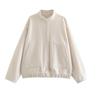 Close-up of cream fleece jacket featuring a high collar and soft sherpa texture