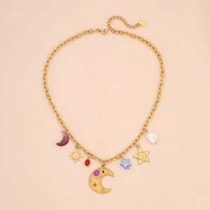 Detail of gold chunky chain necklace with star, moon, and pearl charms for women