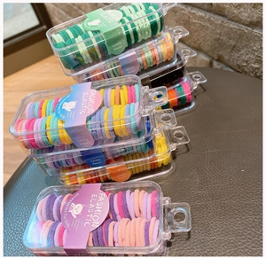 Detail of colorful elastic hair ties in transparent storage boxes for children
