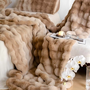 Luxurious faux rabbit fur blanket with soft wavy texture and camel color tone