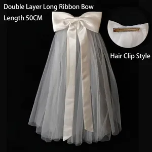 Detail of 50cm double-layer satin bow bridal veil with metal hair clip attachment