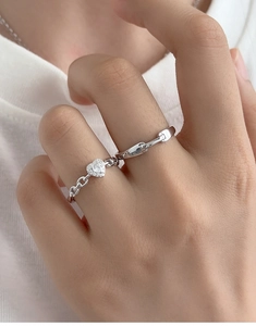 Close-up of S925 silver adjustable heart ring with sparkling diamond inlay on hand