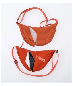 Cross-section of low-quality nylon sling bag showing damaged inner lining and materials