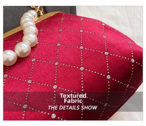 Close-up of red velvet shell bag featuring quilted sequins and elegant pearl handle