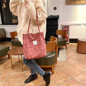 Pink floral corduroy tote bag detail showing large capacity and soft fabric on shoulder