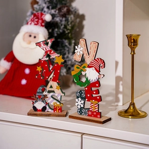 Detail of XMAS and NOEL wooden Christmas gnomes ornaments on a white festive table