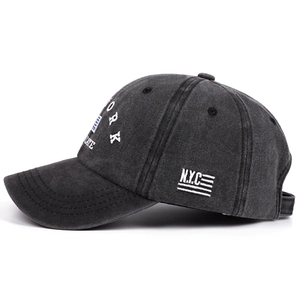 Vintage washed black baseball cap featuring New York NYC white letter embroidery on a plain background