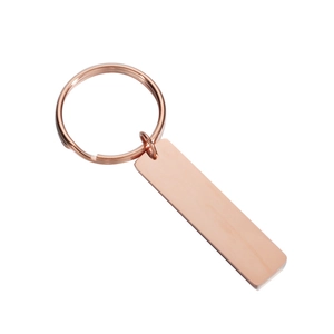Close-up of polished rose gold rectangle bar keychain with metal ring and mirror finish