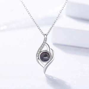 Detailed view of teardrop necklace with zircon paving and black projection stone