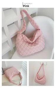 Detail view of pink quilted nylon tote bag with puffer texture and wide shoulder strap