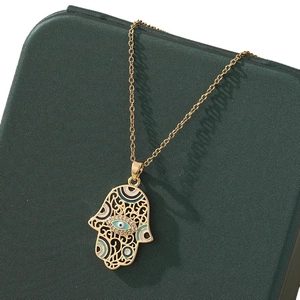 Golden Hamsa necklace with Turkish Evil Eye pendant and intricate zircon embellishments